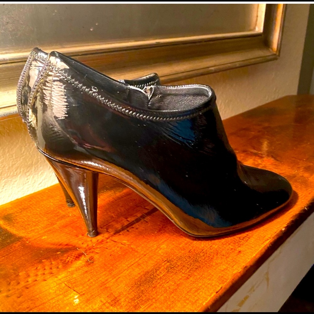 Black patent leather Prada bootie heels.